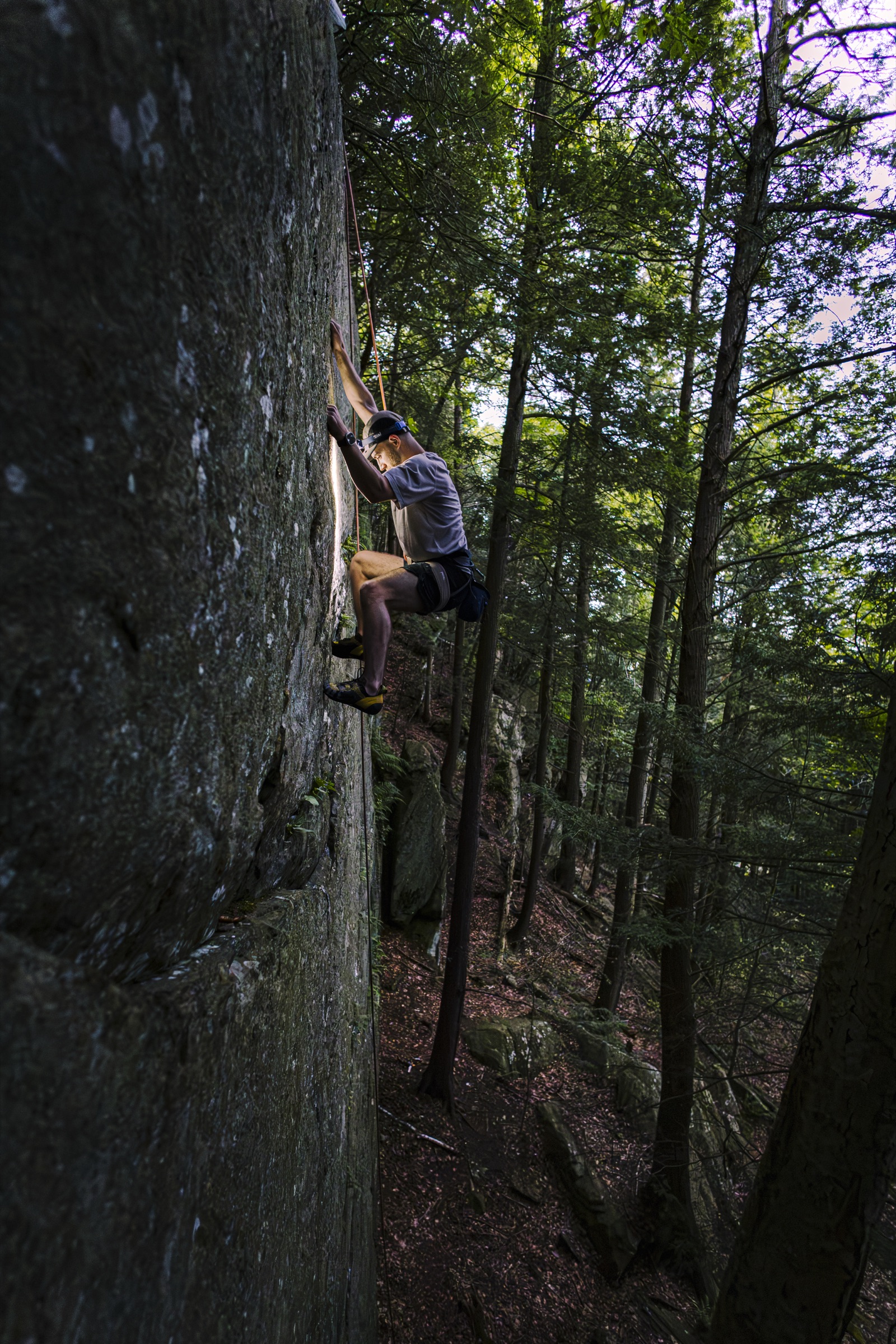 Tom Tranfaglia climbing a boulder